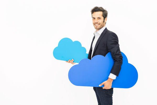 Man in suit holding clouds