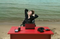 Businesswoman on an office table at the beach