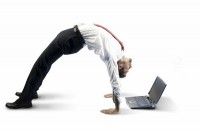 Flexible man looking at laptop