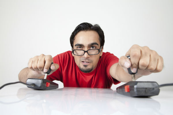 Geek gamer playing with joysticks