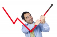 Businessman holding an upward graph arrow