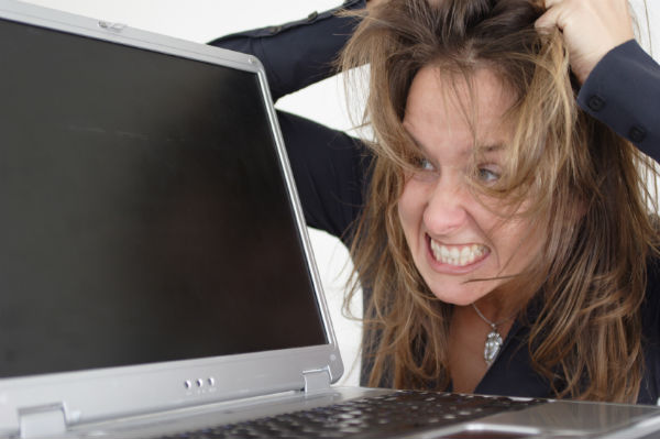 Frustrated woman in front of a laptop