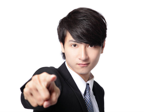 Man in suit pointing at screen