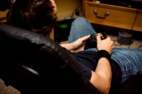 Male gamer sitting on a couch