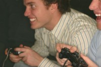 Two men happily playing a video game