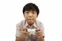 Japanese boy eagerly playing a video game