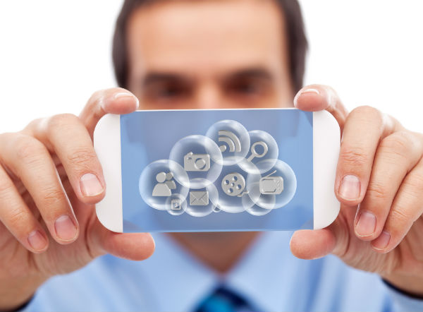 Businessman holding a cloud gadget with various application images