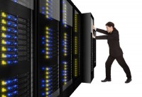Businessman pushing a server rack in place